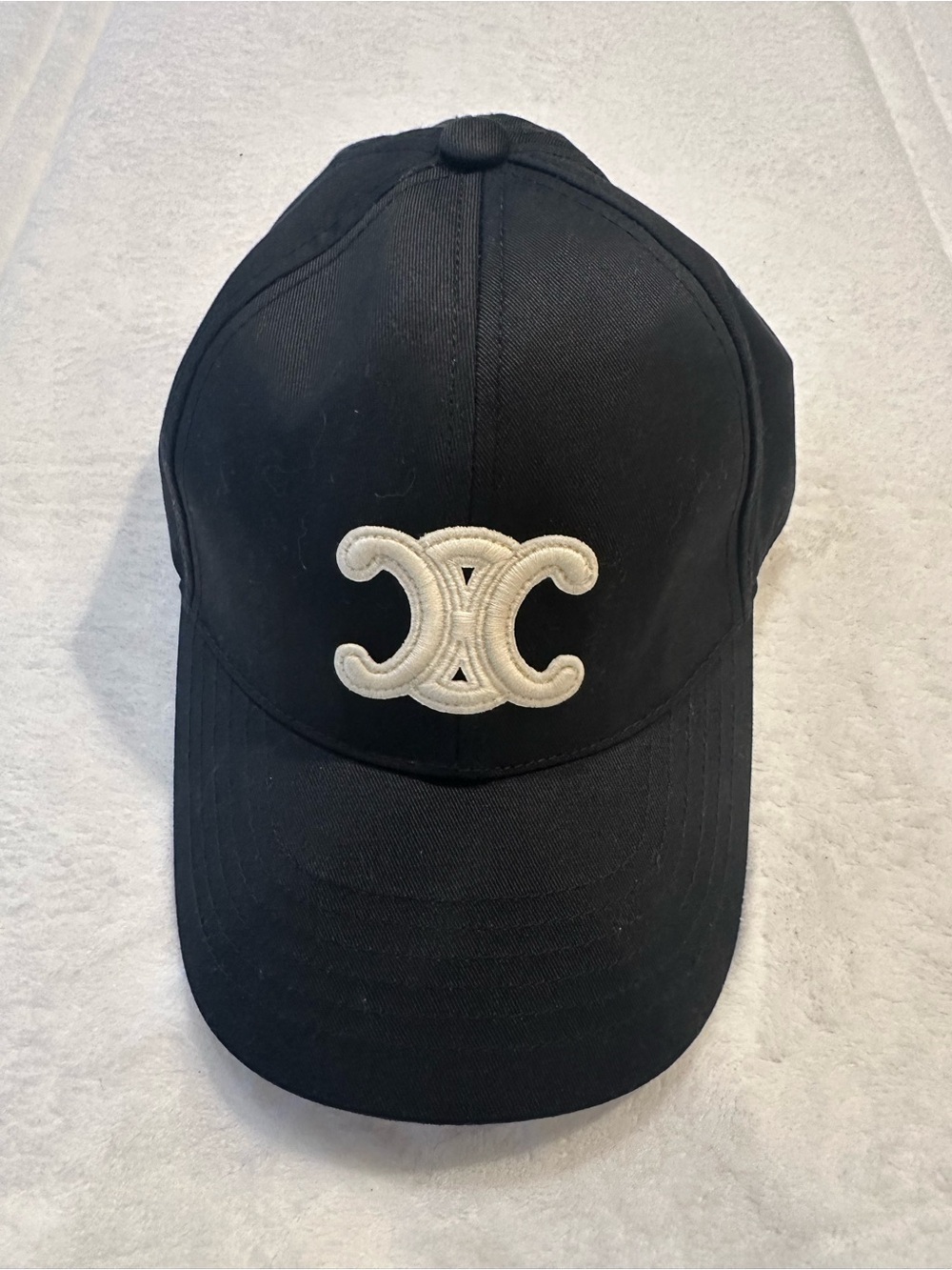 Fashion Inspired Black Baseball Cap with Cream Embroidered Logo